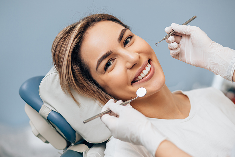 woman receiving dental care while smiling