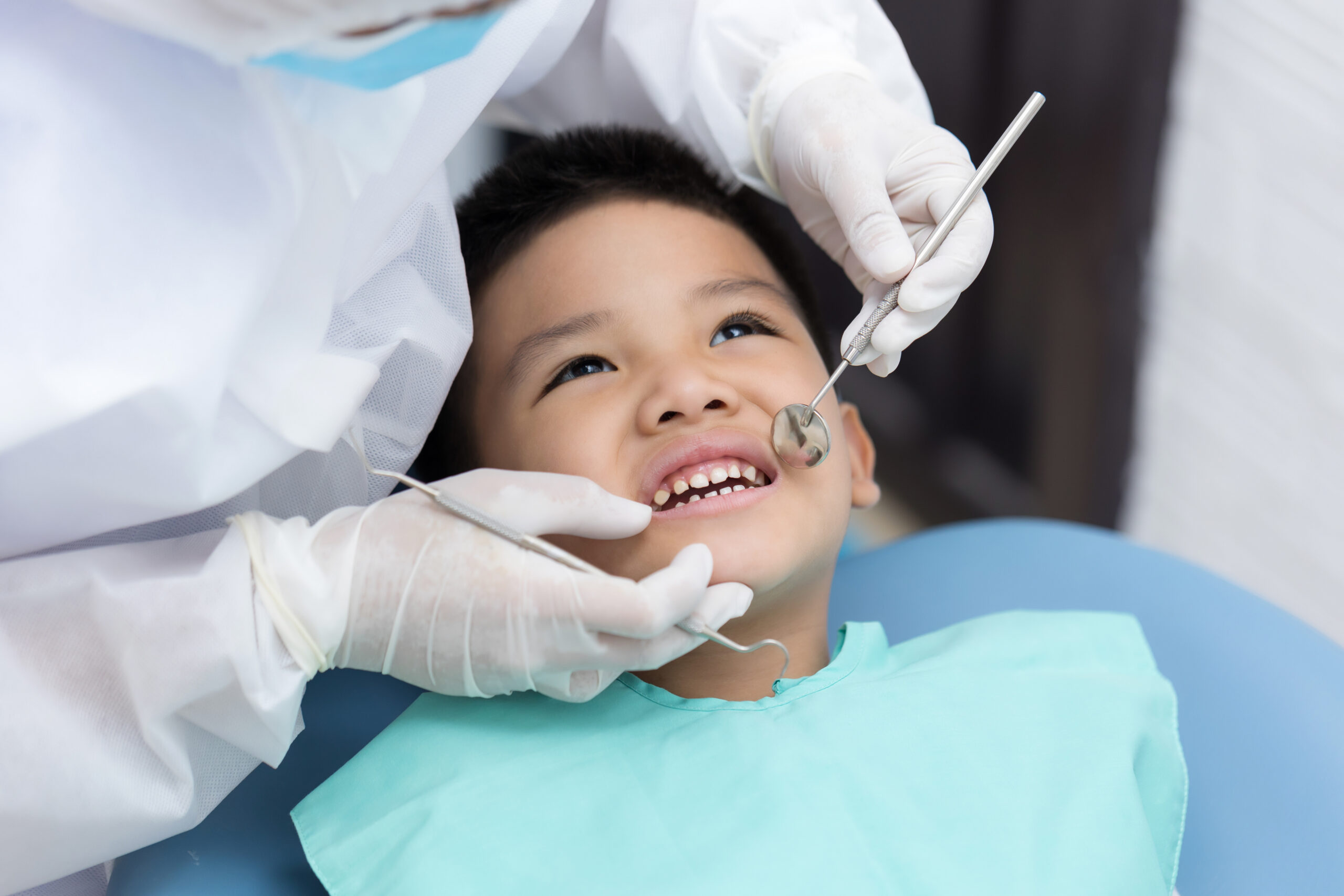 Dedicated Dental child smiling receiving dental care
