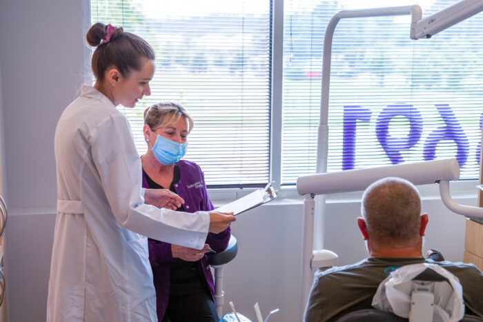 Dr. Knight providing patient care Dedicated Dental